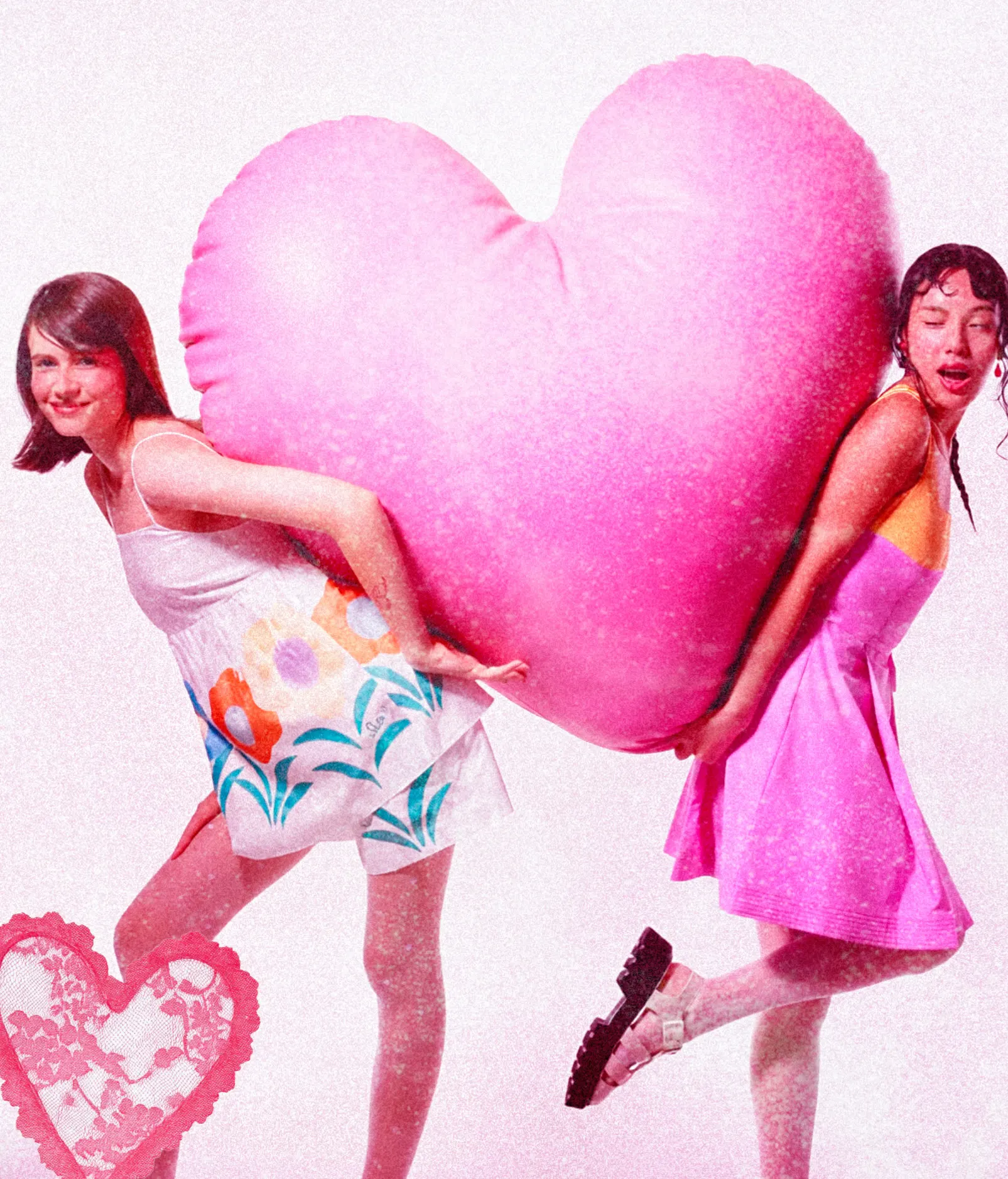 Two people carrying a giant pink heart