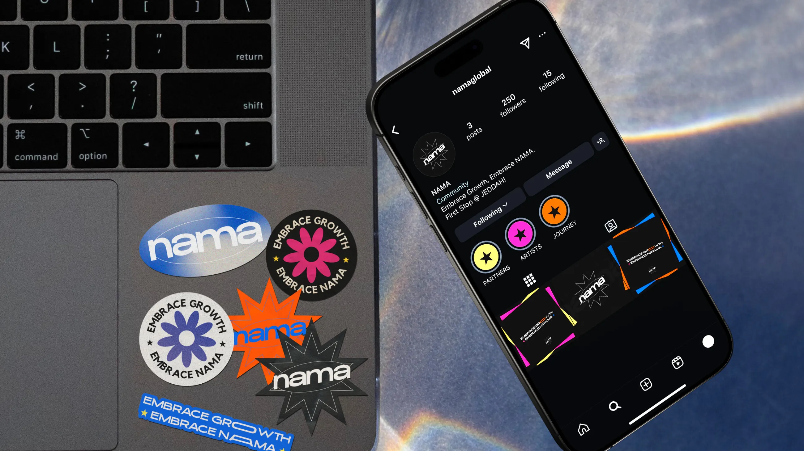 Nama stickers on a laptop beside a phone showing the Nama social profile